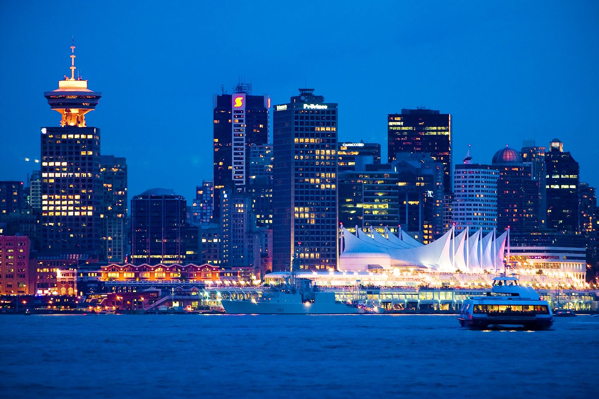 Downtown Vancouver skyline at blue hour, Canada Place lit against the harbour